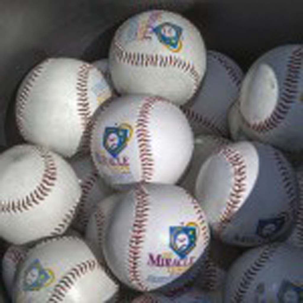 Baseballs for use in the Home Run Derby wait their turn to be hit out of the park. Photo by Bill Reilly