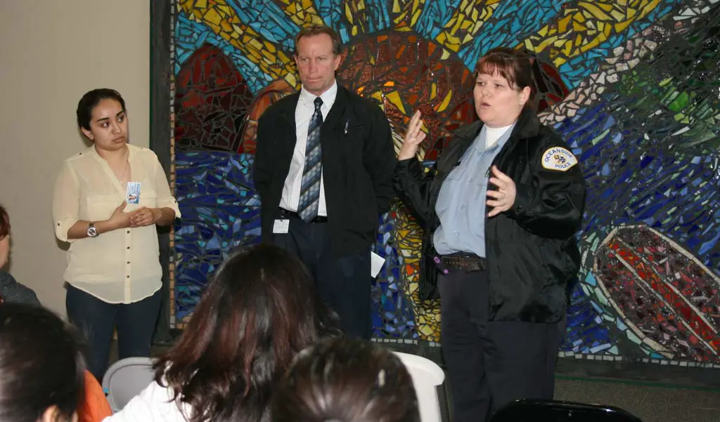 (Left to right) Divina Hernandez, of neighborhood services, Oceanside Police Captain Ray Bechler and officer Dolce Fish update residents on recent arrest related to the March 13 shooting. Suspects arrested are Martin Melendrez of Vista, Michael Zarita of Vista and Santo Diaz of Oceanside. Photo by Promise Yee