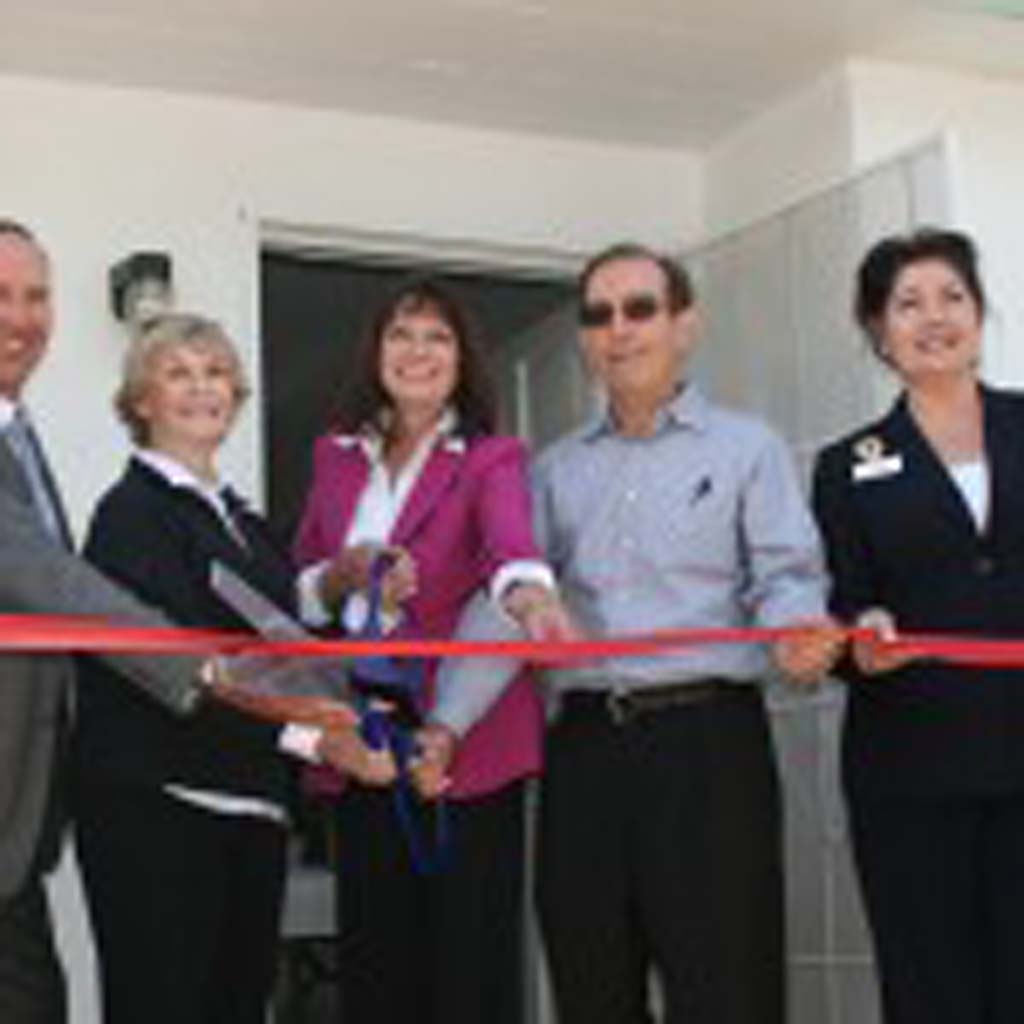 From left: Don Stump, of North County Lifeline; Mayor Judy Ritter; Alexis Parker, of HomeAid; Mike Hall, of Hallmark Communities; and Councilwoman Amanda Rigby cut a ribbon to open Life Spring House. The transitional home will serve young men who aged out of Foster Care Services. Photo by Promise Yee