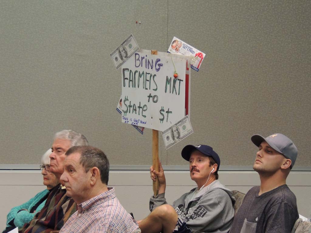 Carlsbad resident and business owner Jim Clark holds a sign at the May 15 Planning Commission meeting in support of relocating the city farmers market to State Street. “This will liven up this dead city,” he said during public comments. Photo by Rachel Stine
