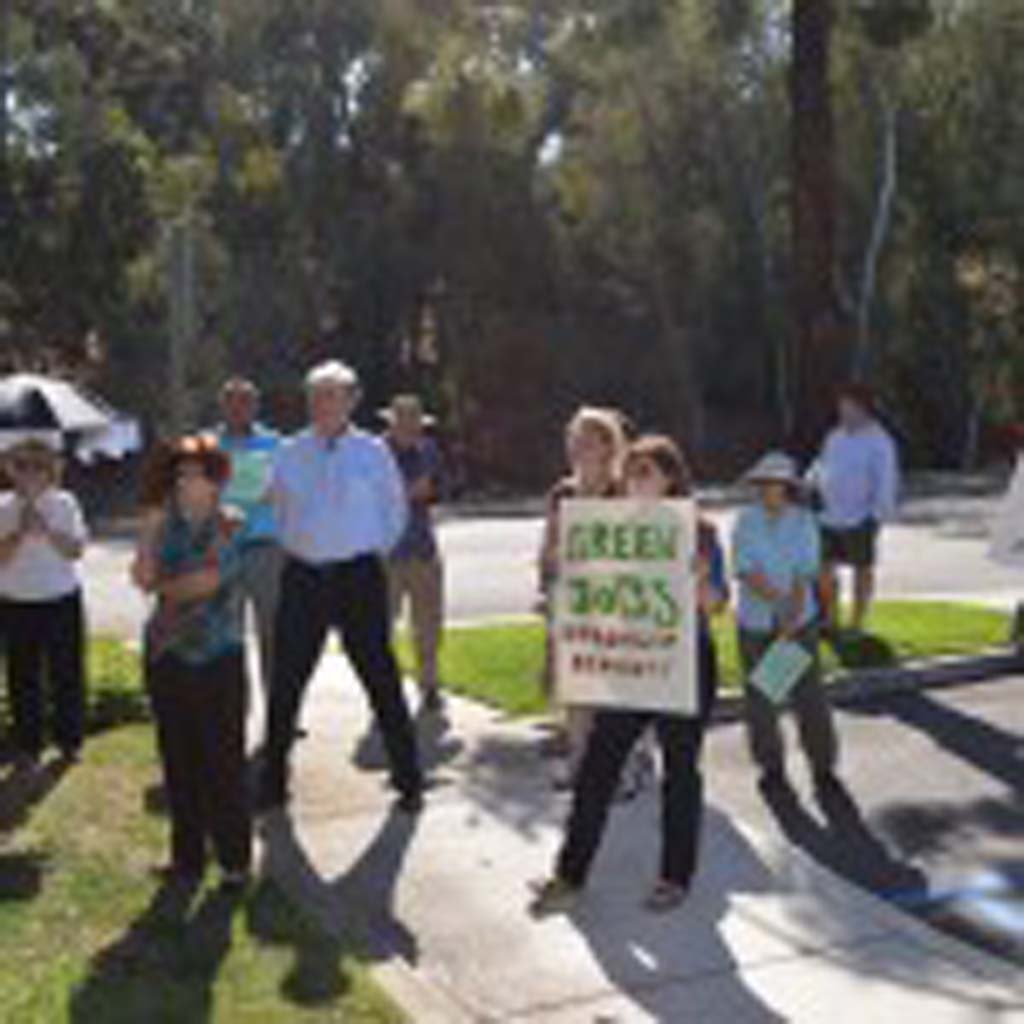 Residents that form part of the local chapter of Organizing for Action gather outside of 49th Congressional District representative Darrell Issa’s office in the hopes of talking about climate change. Photo by Jared Whitlock
