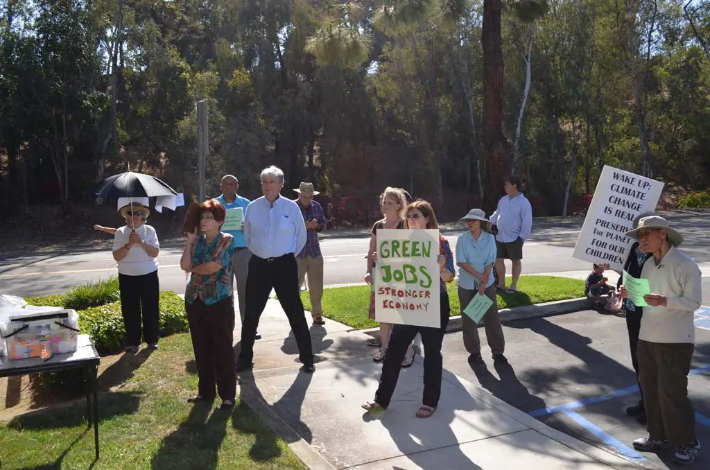 Residents that form part of the local chapter of Organizing for Action gather outside of 49th Congressional District representative Darrell Issa’s office in the hopes of talking about climate change. Photo by Jared Whitlock