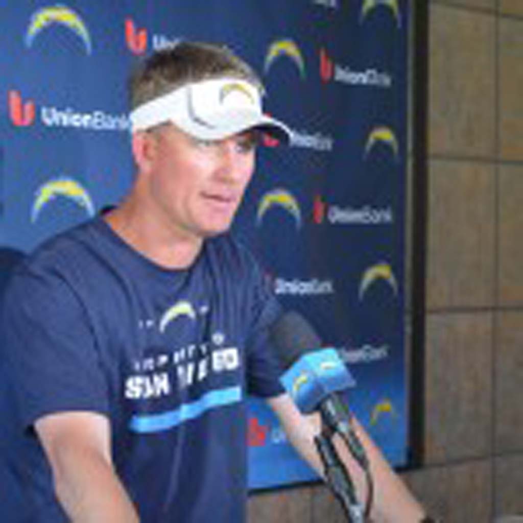 Head Coach Mike McCoy talks to media following the Chargers first OTA. It’s the first time McCoy has had a chance to see every player on the team this year. Photo by Tony Cagala