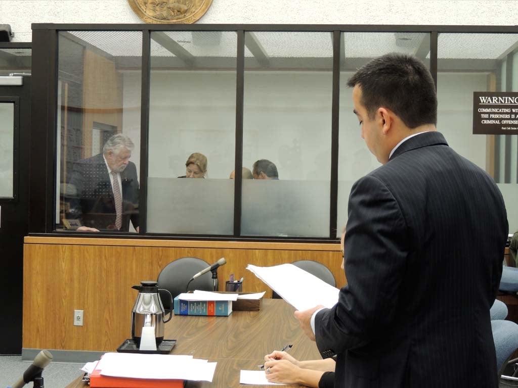 Deputy District Attorney David Uyar, right, reads a letter from the victim during the sentencing proceedings of Marcial Garcia Hernandez, who is listening to the reading via translators in the windowed court cell. Hernandez was sentenced to 23 years to life in prison for raping and enslaving his 12-year-old niece. Photo by Rachel Stine