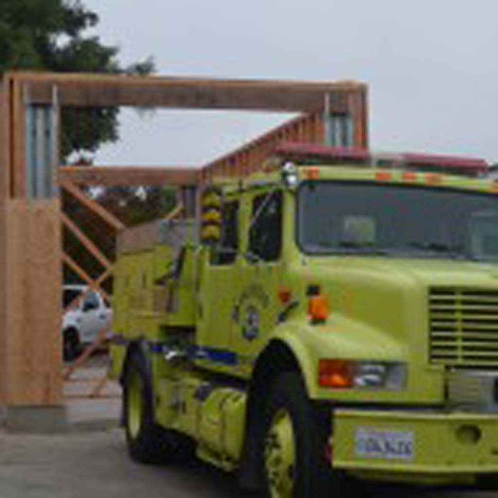 A Type 3 fire engine sits out front of a partially completed garage at Fire Station No. 6 in Olivenhain. Since going from 12-hours of operation to 24-hours, and the addition of three new firefighters, the station is undergoing several upgrades. Photo by Tony Cagala