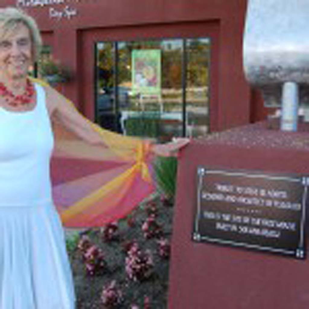 Nadine Frymann shows off a plaque she had installed on her property, Plaza 101 Center, to honor late architect Steve Adams. Photo by Bianca Kaplanek