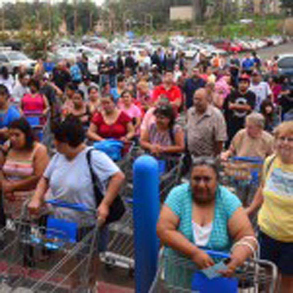 Shoppers line up before entering the new Walmart in Escondido during the grand opening on Wednesday. The store is the first in the city with a second Walmart grocery store to open nearby sometime early next year. Photo by Tony Cagala