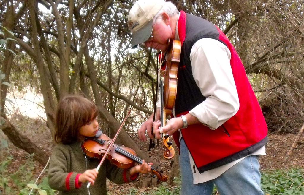 Encinitas residents R. Avery Ellisman, right, and son Ezra at the Santa Barbara Fiddlers Convention in 2009. Founder of the Julian Family Fiddle Camp, Ellisman is sharing the fiddling experience with coastal residents with a special performance by Canadian fiddle maestro, Calvin Vollrath, at the Olivenhain Meeting Hall Oct. 23. Courtesy photo