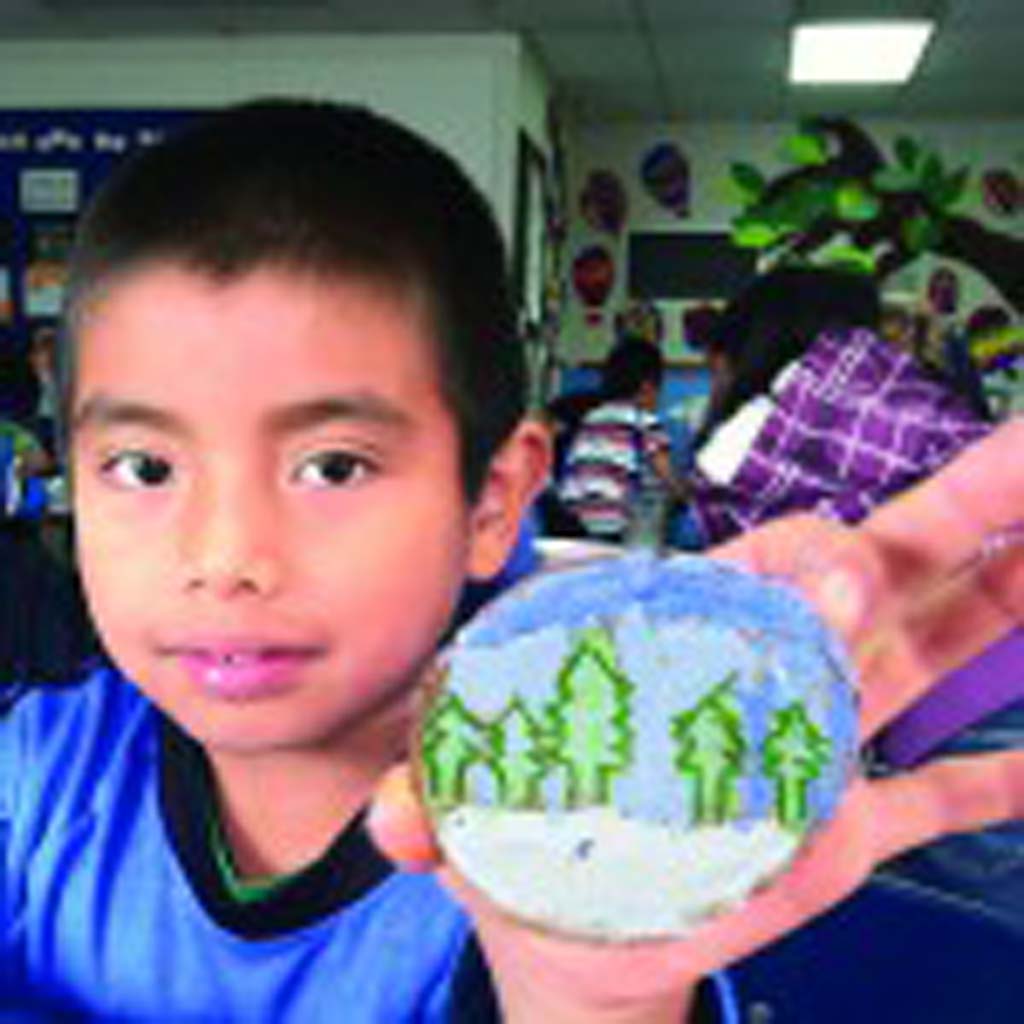 Ocean Knoll Elementary School third-grader Andy Perez shows off his log slice ornament for California’s tree at the 2013 National Christmas Tree display in Washington, D.C.