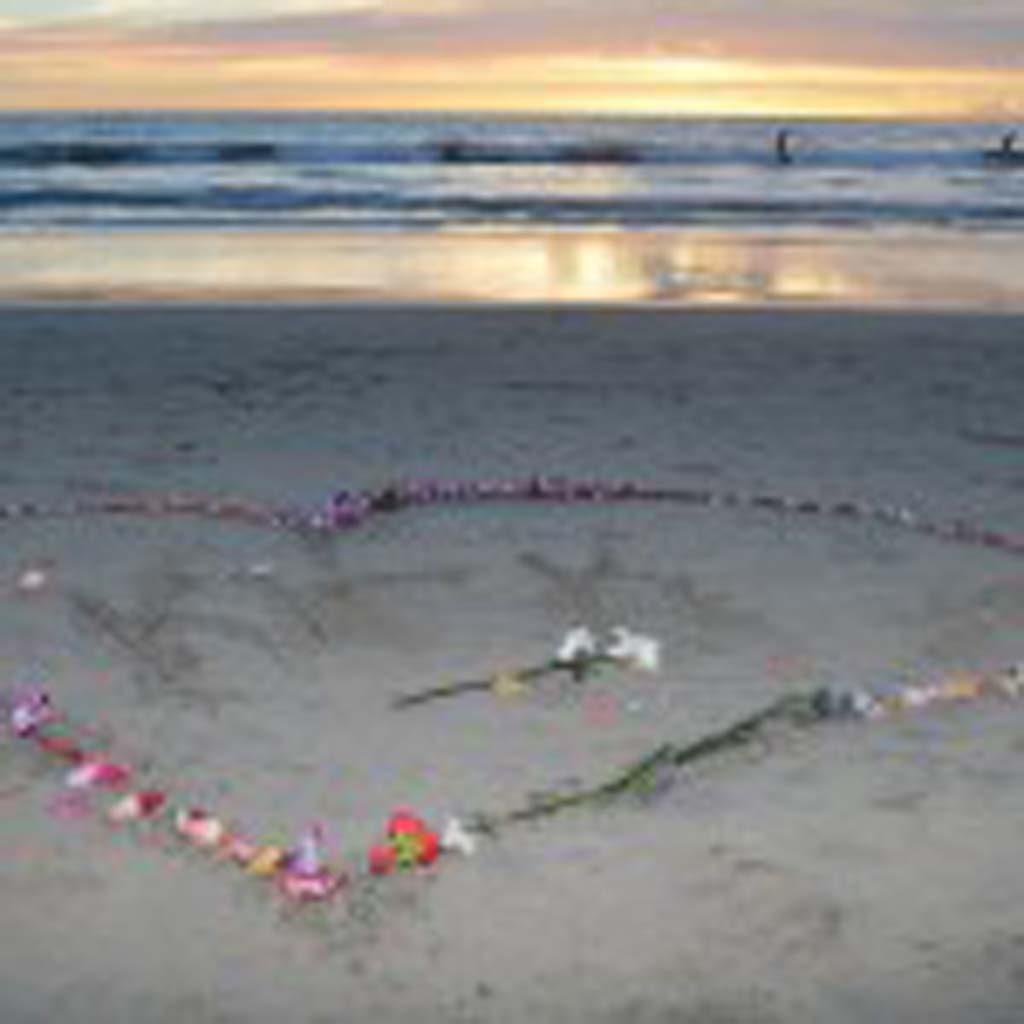 An impromptu memorial to Kirk Passmore is etched into the sands.
