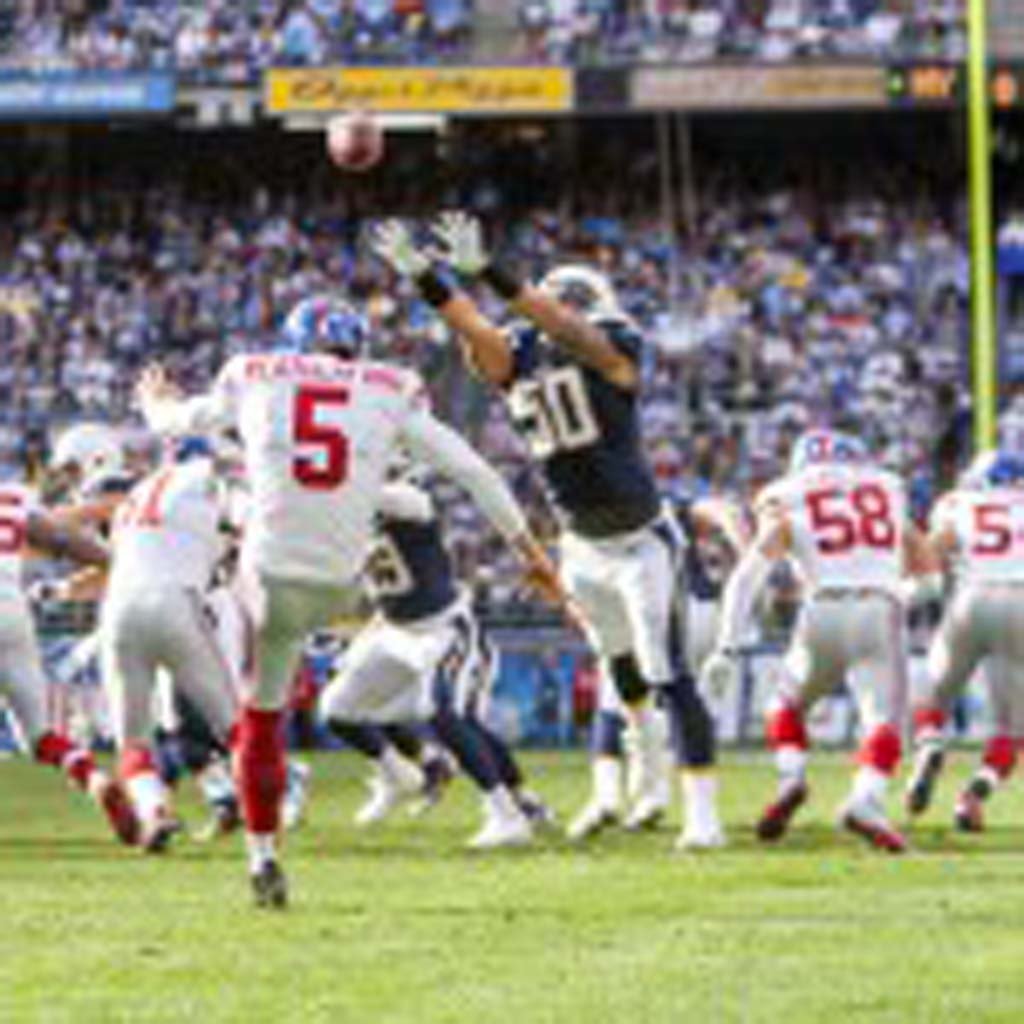 Chargers line backer Manti Te’o (50) comes close to blocking a punt by Giants punter Steve Weatherford (5). The Chargers went on to beat the Giants 37 - 14.