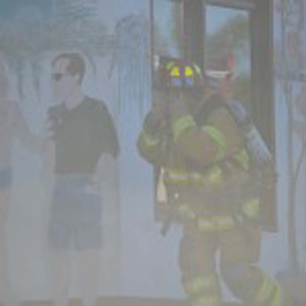 A firefighter walks through smoke to get inside the El Callejon restaurant on Thursday morning. Photo by Tony Cagala
