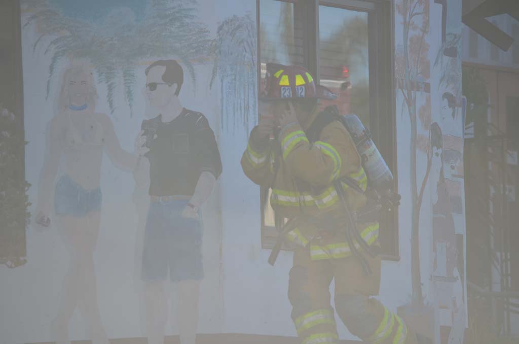 A firefighter walks through smoke to get inside the El Callejon restaurant on Thursday morning. Photo by Tony Cagala