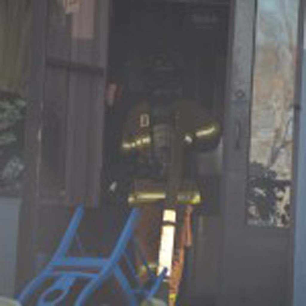 An Encinitas firefighter enters the El Callejon restaurant. Photo by Tony Cagala