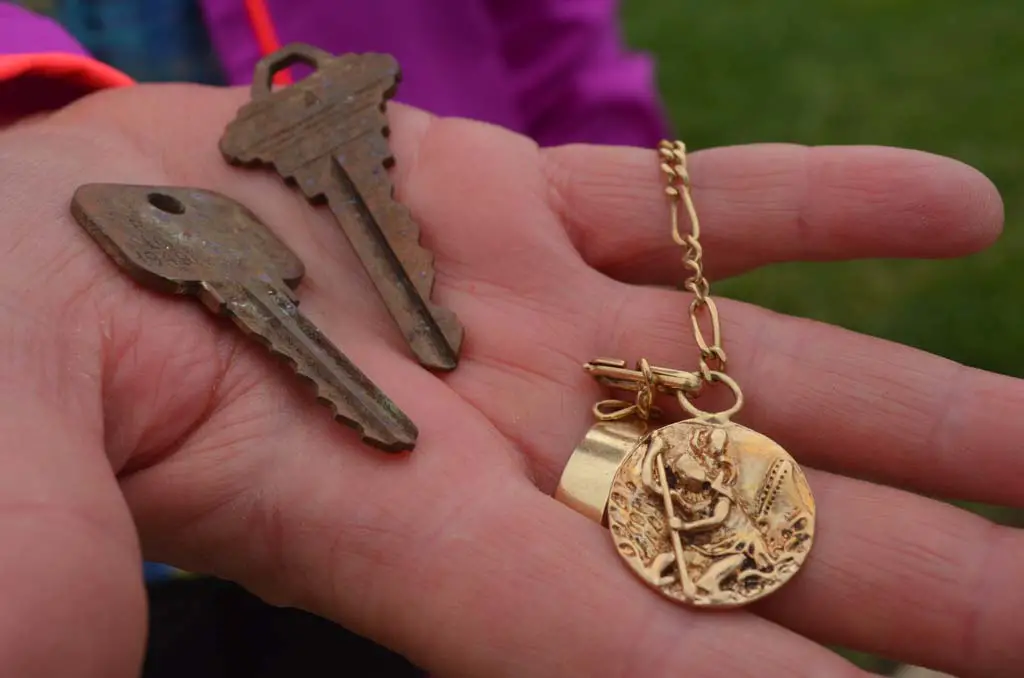 A St. Christopher medal with two keys were found three-inches below ground in Cottonwood Creek Park. Photo by Tony Cagala