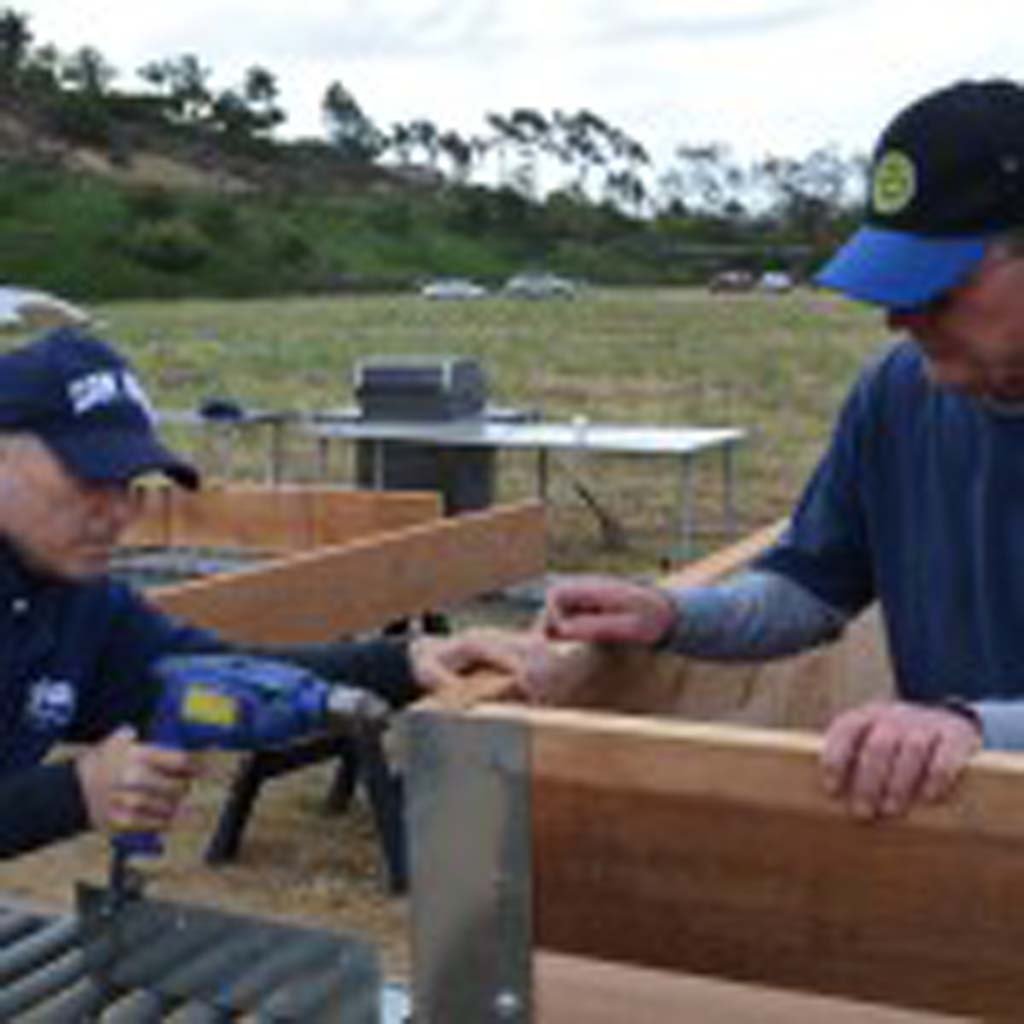 Ron Lieberman (left) drills wood slats together with the help of fellow rotarian Norm Nyberg. They built raised planter boxes for the Encinitas Community Garden. Photos by Jared Whitlock
