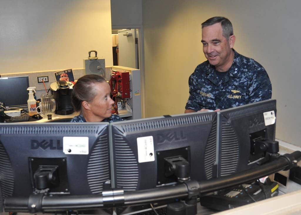 Rear Adm. Russ Penniman, director of Maritime Operations Center, right, discusses current operations with Cmdr. Sara Crawford, the battle watch captain, during a visit to the operations floor at U.S. Pacific Fleet (PACFLT) headquarters. Penniman, a Rancho Santa Fe resident has served in the Navy since 1979. U.S. Navy Photo by Mass Communication Specialist 1st Class David Kolmel