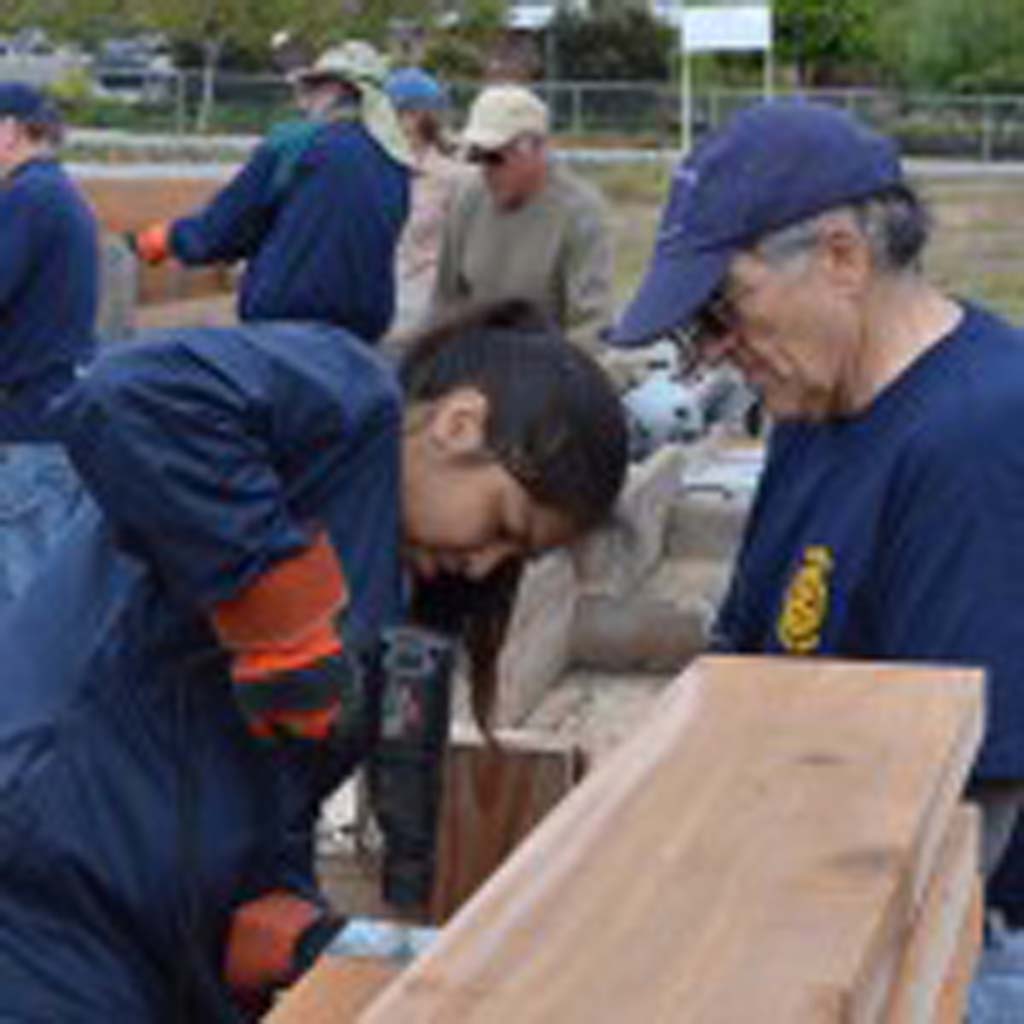 Rotarians work on a planter box.