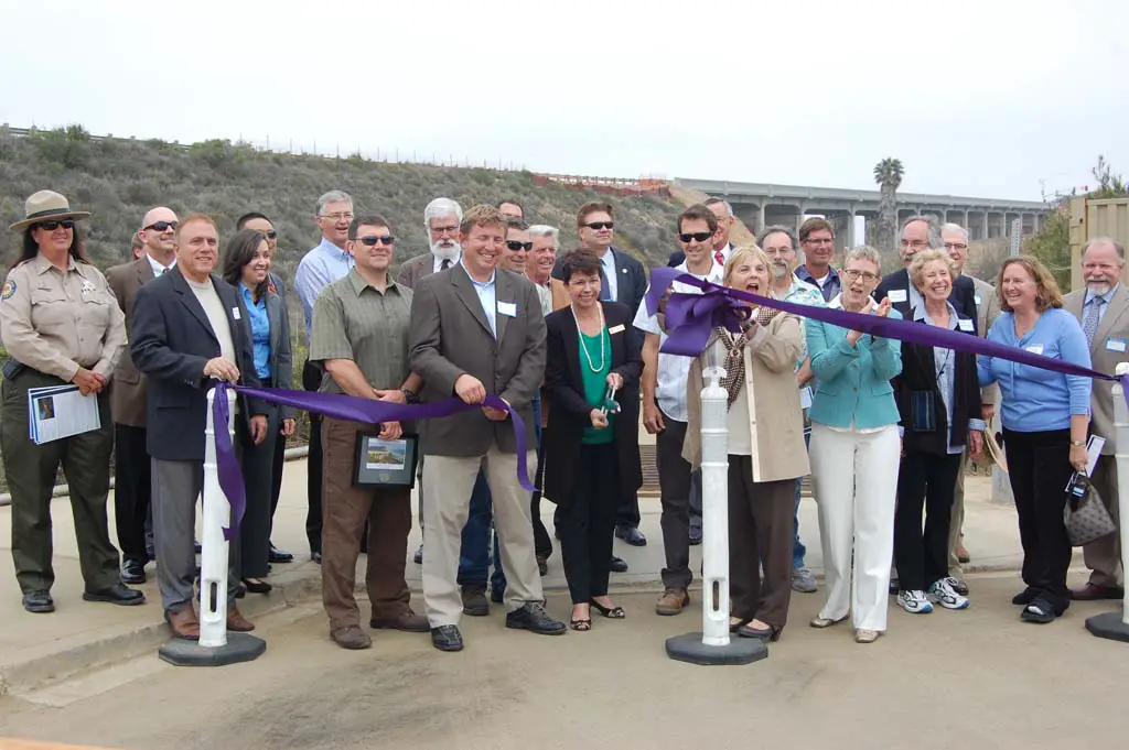 Current and former City Council and staff members, contractors and representatives from the California Department of Transportation and Federal Highway Administration take part in the ribbon cutting. Photo by Bianca Kaplanek