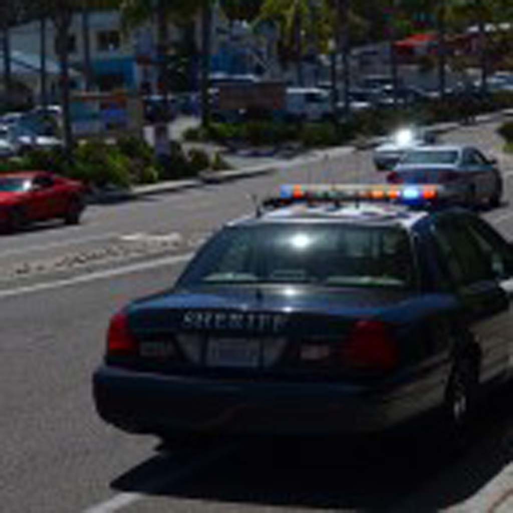 A law enforcement vehicle patrols downtown Encinitas on Monday looking for a man who allegedly pushed a Sheriff’s deputy and fled on foot. Photo by Jared Whitlock