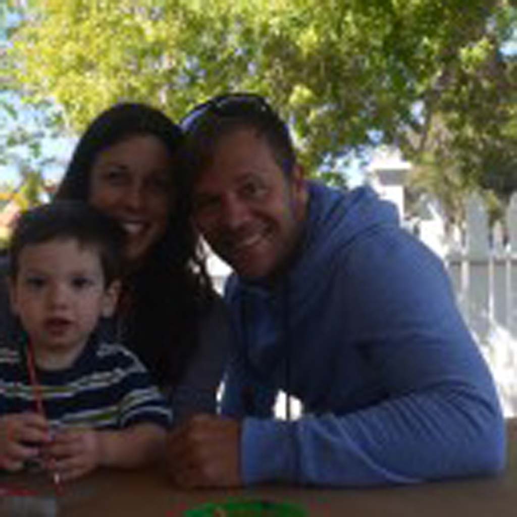 Parents Mary and Beau Moffatt with their son Elijah at the rock painting station. Photo by Tony Cagala