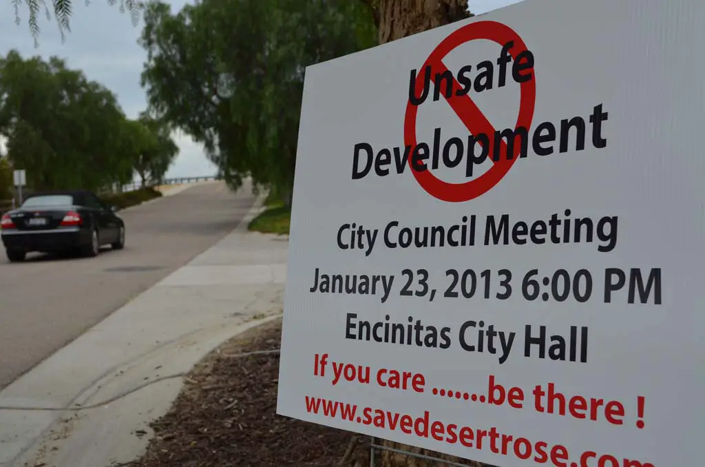 A sign last year advocates against the “Desert Rose” development in Olivenhain. A Superior Court judge recently ruled the project developer must complete an environmental impact report. Doing so would shrink the project’s footprint, those opposed to the project believe. File photo by Jared Whitlock