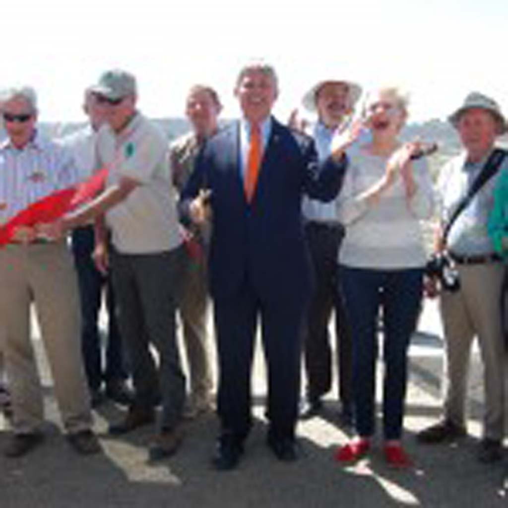On hand for the ribbon cutting are, from left, David Kay, from Southern California Edison, San Dieguito River Valley Conservancy President Peter Shapiro, San Dieguito River Park Executive Director Dick Bobertz, County Supervisor Dave Roberts, his predecessor Pam Slater-Price, San Dieguito River Valley Conservancy Executive Director Trish Boaz and members of the conservancy and joint powers authority. Photo by Bianca Kaplanek