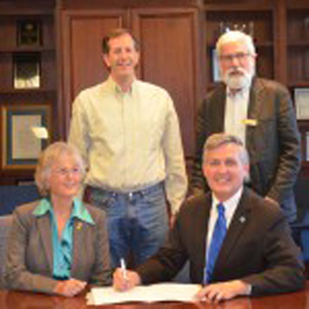 In a ceremonial signing on May 16, members of the Joint Powers Authority, from left: County Supervisor Dianne Jacob, Solana Beach City Councilman Dave Zito, Del Mar City Councilman Don Mosier and County Supervisor Dave Roberts, extend the agreement for another 50 years. Photo by Tony Cagala