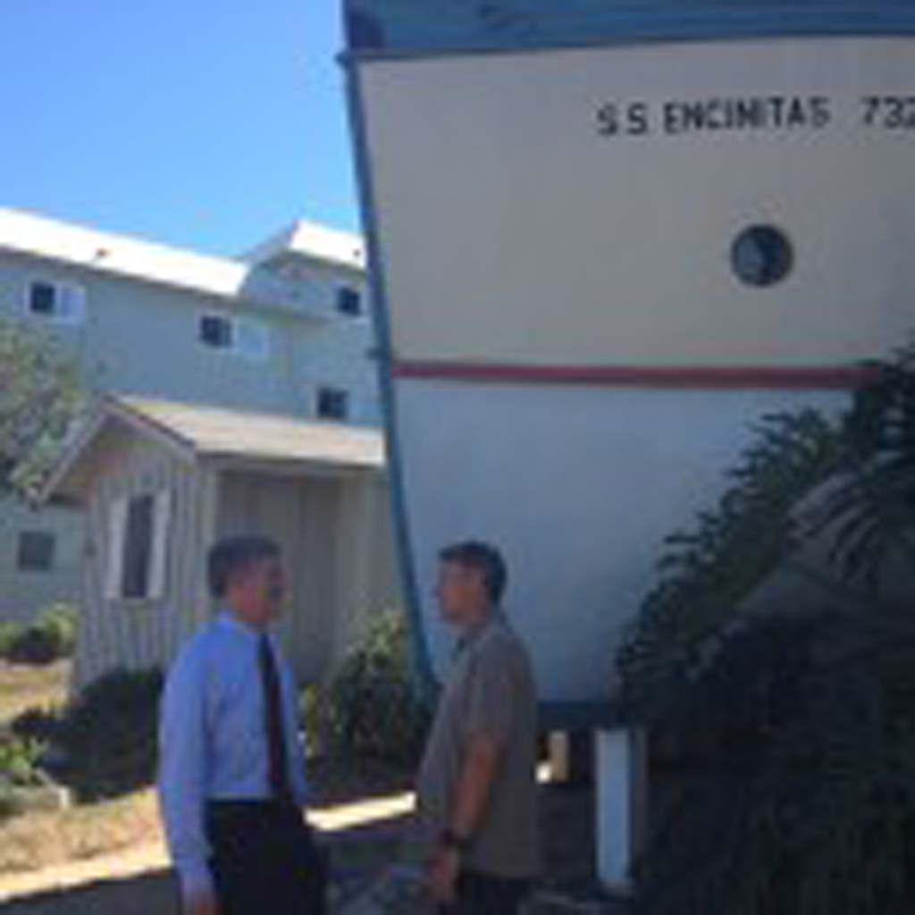 San Diego County Supervisor Dave Roberts, left, talks with Tom Cozens, founder of the Encinitas Preservation Association on Tuesday outside the well-known boathouses in Encinitas. Photo by Aaron Burgin