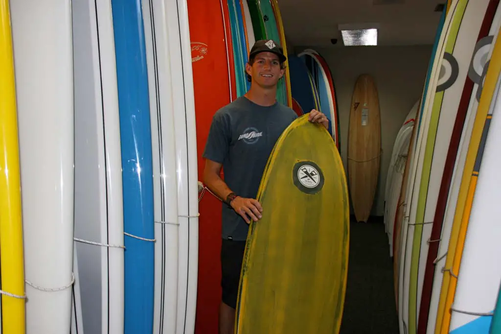 Josh Bernard, Surf Ride CEO, shows off a Surf Ride board. Surf Day was declared in Oceanside in recognition of the surfing industry. Photo by Promise Yee