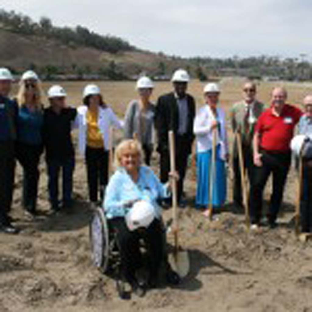 City staff, developers and housing commissioners cheer the groundbreaking at Mission Cove. First occupants are anticipated to move into the affordable housing project in two years. Photo by Promise Yee