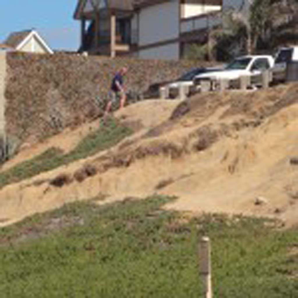 Bluff erosion is sped up when people use the face of the bluff to access the beach. City officials approved funding towards the addition of a low fence near the Ocean Street parking lot in order to minimize pedestrian access on the bluff. Photo by Ellen Wright