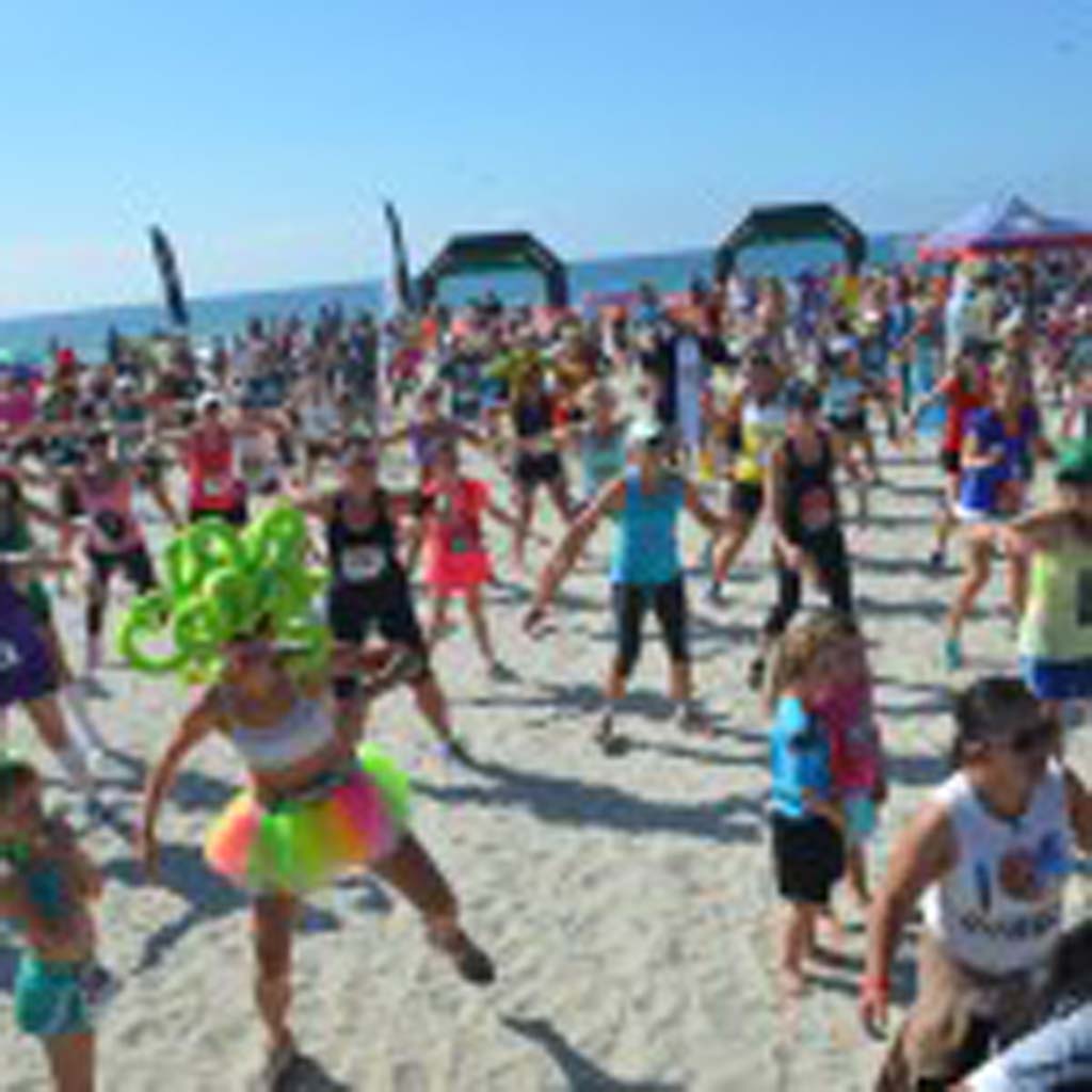 A large crowd takes part in a Zumba event prior to the start of the second annual Surfing Madonna 5K/10K race on Saturday. Photo by Tony Cagala