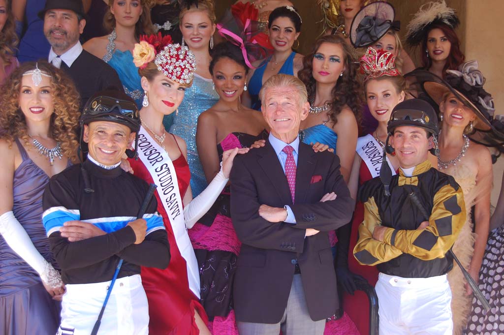 Joe Harper, center, president and CEO of the Del Mar Thoroughbred Club, poses with fashion show contestants and jockeys Mike Smith, left, and Aaron Gryder before the start of the inaugural Bing Crosby Season. Photo by Bianca Kaplanek