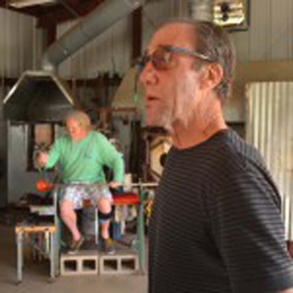 Artist Garry Cohen, right, hosts a weekend glass art demonstration at Glass Ranch, his Del Dios residence and art glass studio. John Pourroy, background, works a piece of glass into a bowl. Photo by Tony Cagala