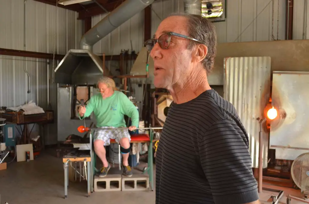 Artist Garry Cohen, right, hosts a weekend glass art demonstration at Glass Ranch, his Del Dios residence and art glass studio. John Pourroy, background, works a piece of glass into a bowl. Photo by Tony Cagala