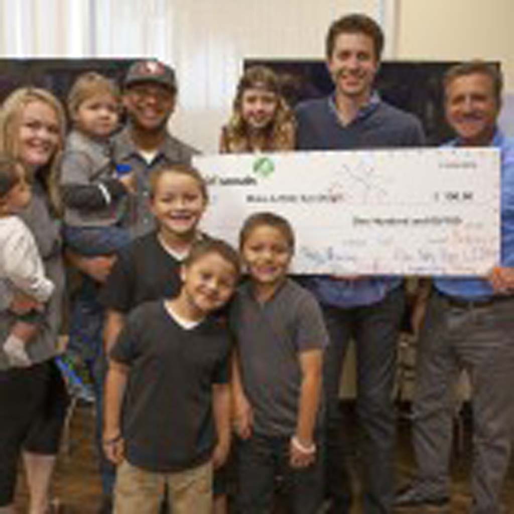 L to R: Wish Kid Benjamin Williams (Benjamin in Dad’s arms holding blue cup); Brownie Kaitlyn Blain; Jason Blain, President, Spinal Elements and Chris Sichel, President and CEO Make-A-Wish San Diego. Courtesy photo