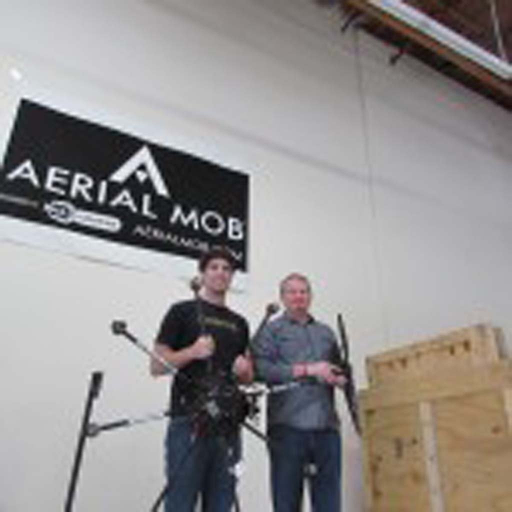 Co-founders Jonathan Montague, left, and Treggon Owens stand in their warehouse with one of their drones, which can cost upwards of $30,000. Photo by Ellen Wright