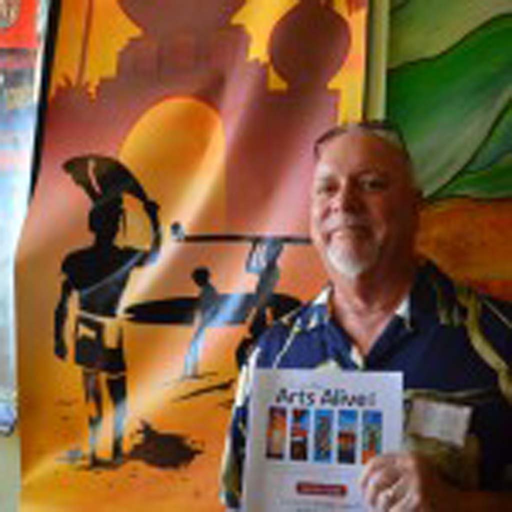 Artist Don Doerfler stands next to his banner “Endless Encinitas,” on Saturday. Photo by Tony Cagala