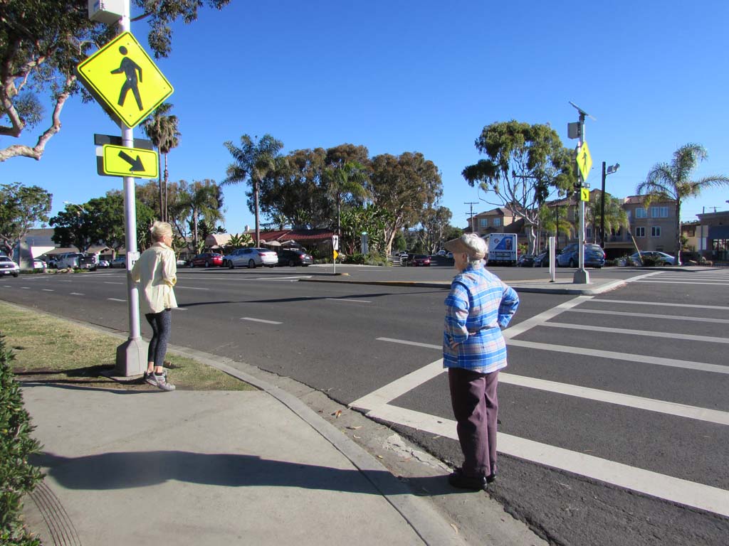 The rectangular rapid flashing beacon on Oak Avenue alerts drivers that pedestrians are trying to cross. Senior Traffic Engineer Doug Bilse said the sign was a pilot program to test drivers’ reactions. No complaints have been received about the sign. Photo by Ellen Wright