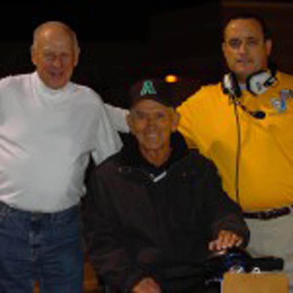 New Oceanside High School football coach David Rodriguez, far right, is taking over the helm from John Carroll, who retired after a long, successful run as coach of the Pirates. Rodriguez was formerly the coach at Sahuarita High School in Arizona. He’s pictured with Herb Meyer, center, a successful football coach in his own right. Courtesy photo
