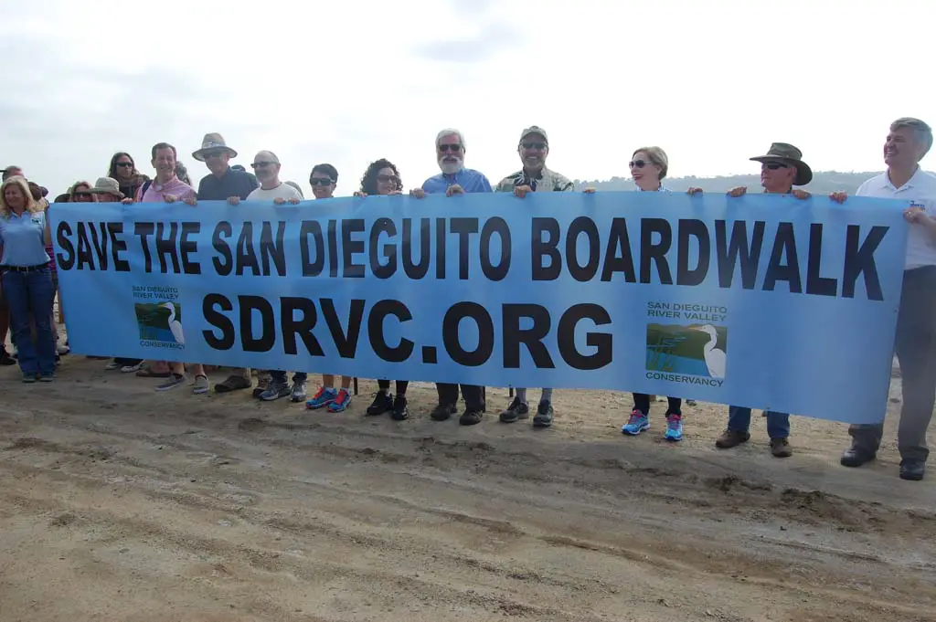 Holding a 20-foot banner created for a March 21 rally are representatives from Del Mar, Solana Beach, the 22nd District Agricultural Association, San Diego County and the San Dieguito River Valley Conservancy. Photo by Bianca Kaplanek