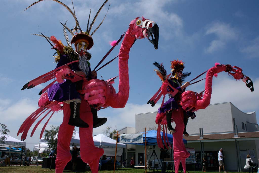 Eclipse and Corto are 10-foot tall, pink birds that are know for their mischief. Dragon Knights Stilt Theater performers portray a variety of fairy tale characters. Photo by Promise Yee