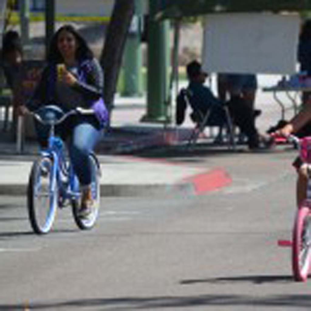 Andrea Fonseca, right, and Sarai Fonseca ride their bikes down a stretch of Grand Avenue in Escondido. Photo by Tony Cagala