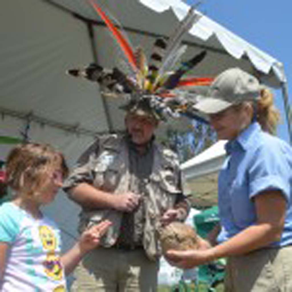 Bella Peirsol, 8, left, gets a chance to touch a three-banded armadillo with Dr. Zoolittle, center, and Rebecca Willetts, from the San Diego Zoo, during Encinitas’ EcoFest. Photo by Tony Cagala