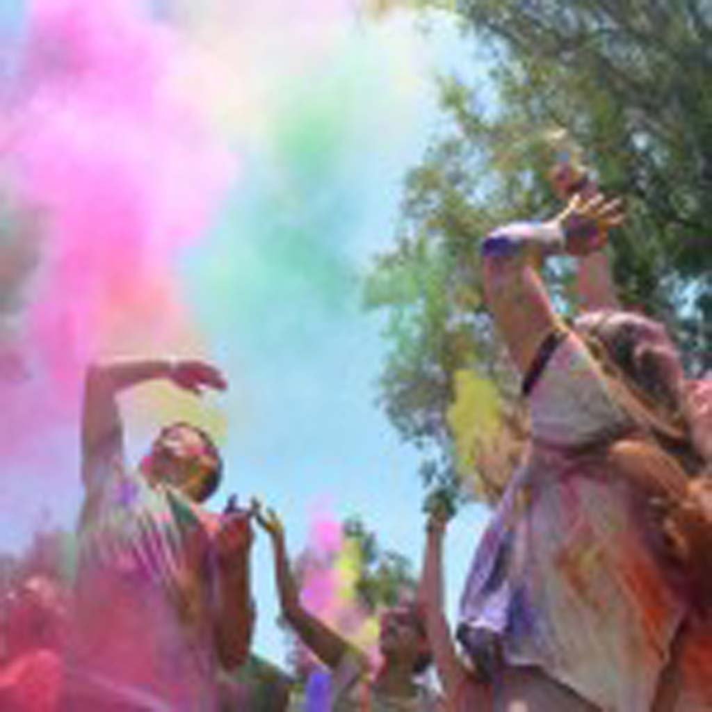 Revelers throw their worries to wind, in this case, colored cornstarch, to help celebrate the Indian tradition of Holi. Photo by Tony Cagala