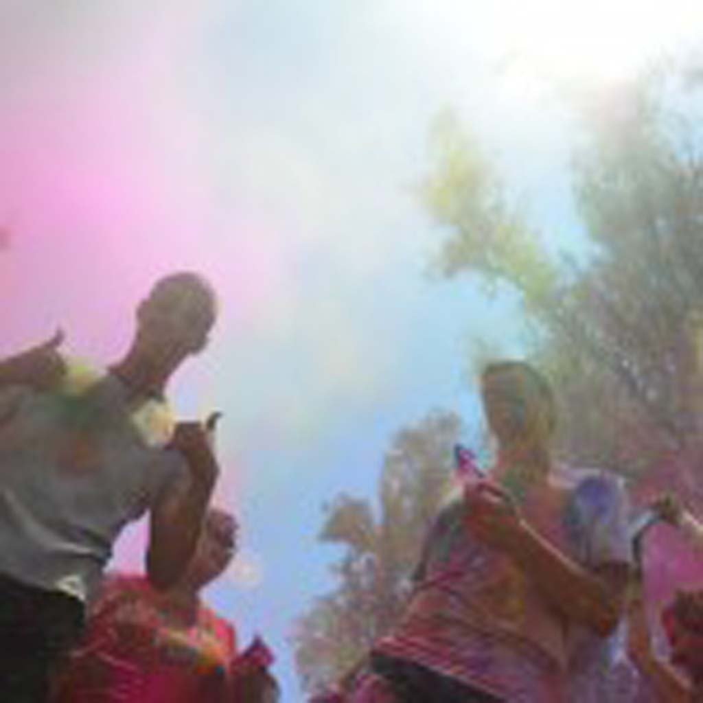 Revelers throw their worries to wind, in this case, colored cornstarch, to help celebrate the Indian tradition of Holi. Photo by Tony Cagala