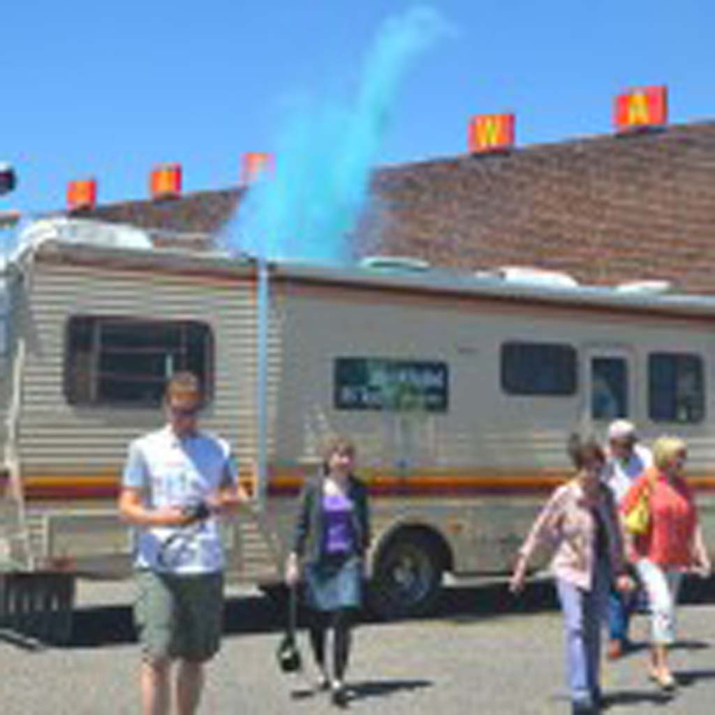 Dylan Wisneski, tour assistant, sets off a blue smoke bomb to mimic a meth-cooking scene from the blockbuster TV series “Breaking Bad.” Frank Sandoval, owner of Breaking Bad RV Tours, conducted a nationwide search for this 1986 Fleetwood Bounder, a duplicate of the two used in the TV series. One was gutted and a makeshift lab installed for the driving scenes; the other met its fate in the crusher (Season 3; Episode 6). The interior scenes were filmed on a set built in a box at an Albuquerque sound stage.