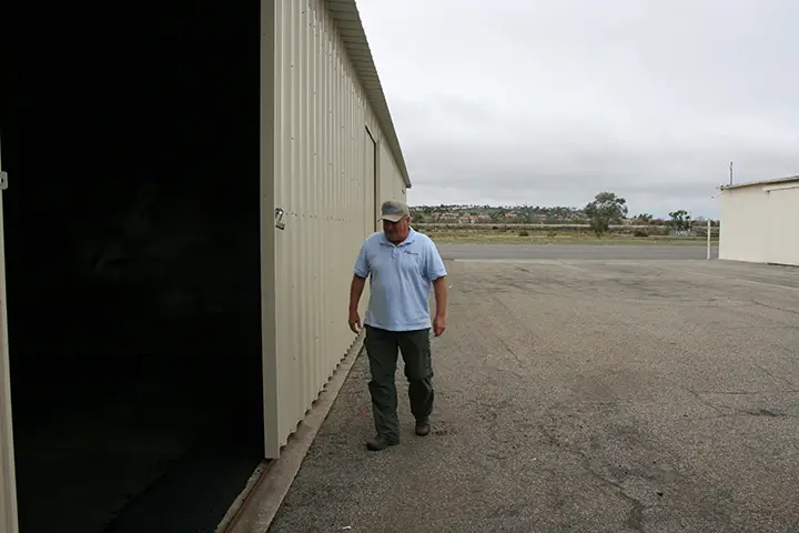 Rick Koehler, airport assistant manger, shows off refurbished hangars. Refurbishment is a fraction of the cost of rebuilding hangars. Photo by Promise Yee