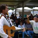 Brian Caldwell, singer of Highland Way, a traditional Scottish folk band, mixes it up with an enthusiastic crowd member. Photo by Tony Cagala